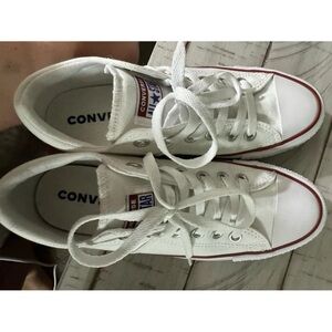 Woman’s white Converse sneakers